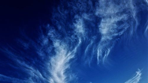 Low angle view of vapor trail in blue sky