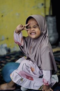 Portrait of cute baby girl using mirrorless camera