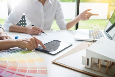 Midsection of people working in office