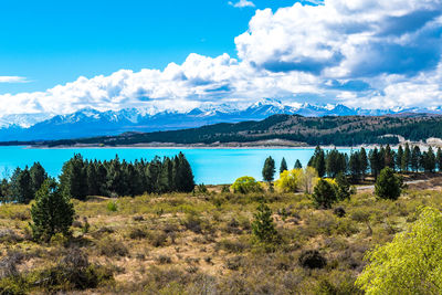 Scenic view of lake and mountains against sky