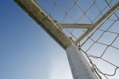 Low angle view of suspension bridge against blue sky