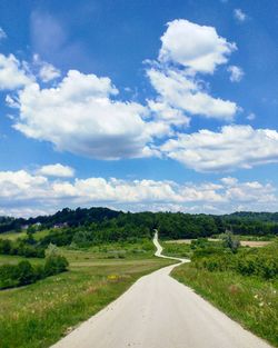 Road by landscape against sky