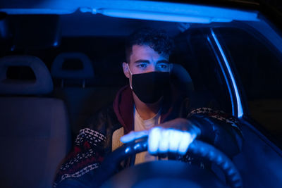 Portrait of man sitting in car