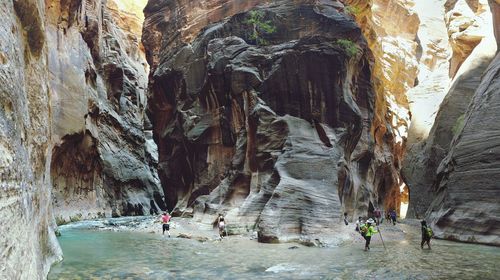 People on rock in cave