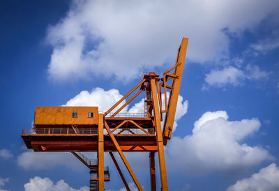 Low angle view of crane against sky