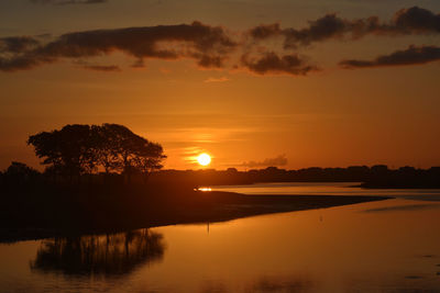 Scenic view of lake against romantic sky at sunset