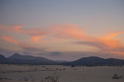 Scenic view of mountains against sky during sunset