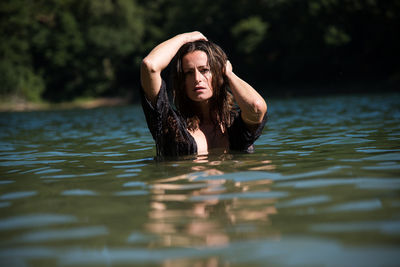 Young woman swimming in lake
