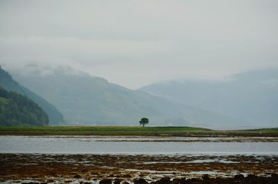 Scenic view of lake and mountains against sky