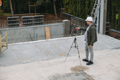 Geodetic works. surveyor engineer using geodetic equipment at construction site. professional