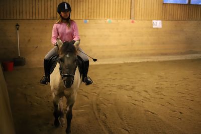 Full length of man riding horse