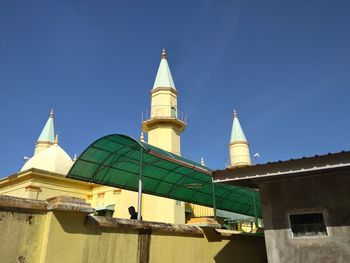 Low angle view of building against clear blue sky