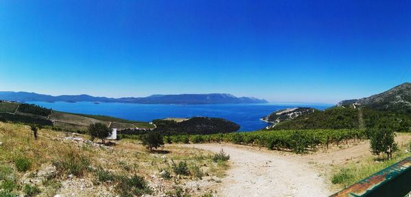 Scenic view of calm lake against clear blue sky