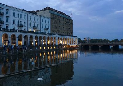 Bridge over river against buildings in city