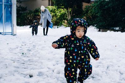 Girl standing on snow covered ground