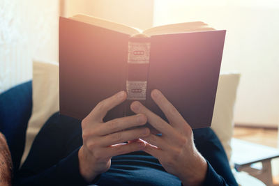 Midsection of woman reading book