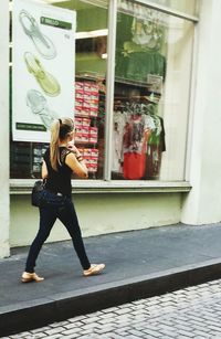 Full length of woman standing by railing