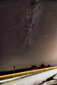 Scenic view of road against sky at night