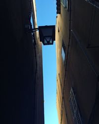 Low angle view of buildings against clear blue sky