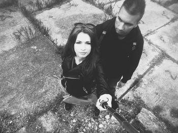 High angle portrait of couple sitting outdoors