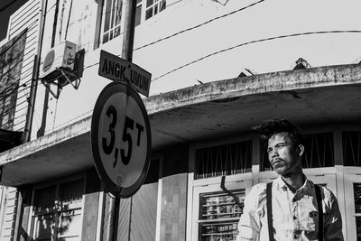 Low angle view of man standing against building