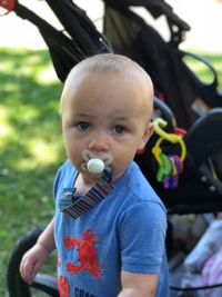 Portrait of cute baby boy with pacifier in mouth