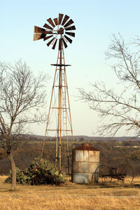 Traditional windmill on field against sky