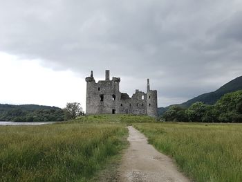 View of historical building in field