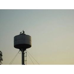 Low angle view of communications tower against sky