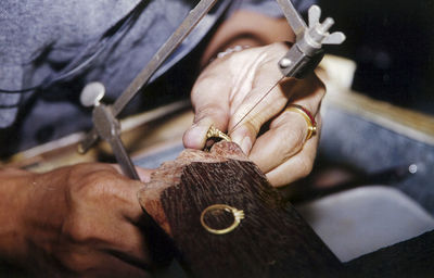 Midsection of person making ring in workshop