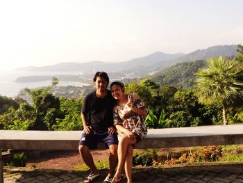 Portrait of young couple against mountains