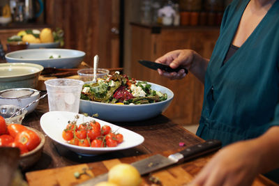 Midsection of woman preparing food on table