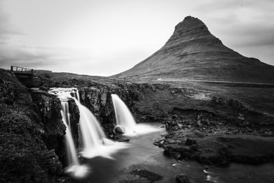 Scenic view of waterfall against sky