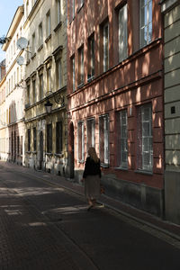 Rear view of woman walking on street