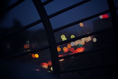 Low angle view of illuminated lights against sky