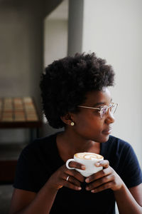 Portrait of woman holding coffee cup