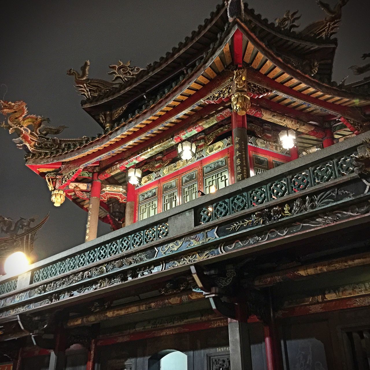 architecture, built structure, low angle view, illuminated, night, building exterior, place of worship, religion, spirituality, temple - building, architectural column, text, famous place, tradition, travel destinations, non-western script, red, history, ornate, culture