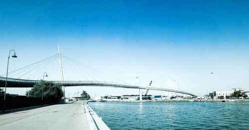 Bridge over river with city in background