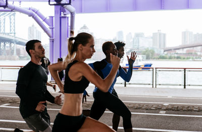 People running on road in city