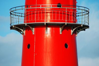 Low angle view of red lighthouse against sky