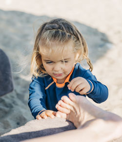 Cute girl touching foot