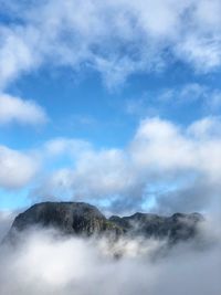 Low angle view of volcanic mountain against sky, norway