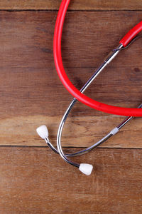 Close-up of red stethoscope on table