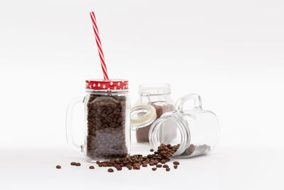 Close-up of glass jar against white background