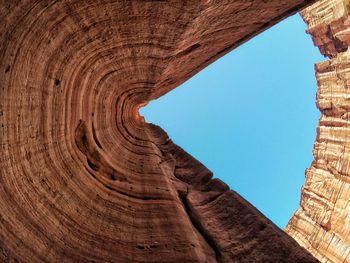 Low angle view of canyon against clear blue sky