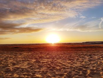 Scenic view of beach against sky during sunset