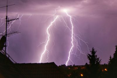 Low angle view of lightning against sky at night