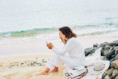 Woman sitting on beach