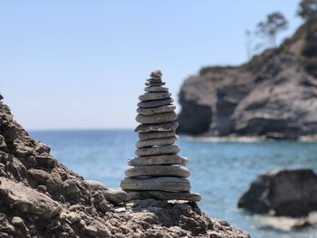 Stack of rocks on beach against sky