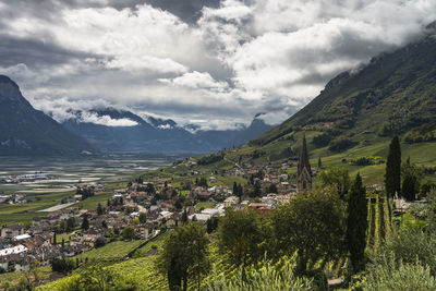 Scenic view of townscape and mountains against sky